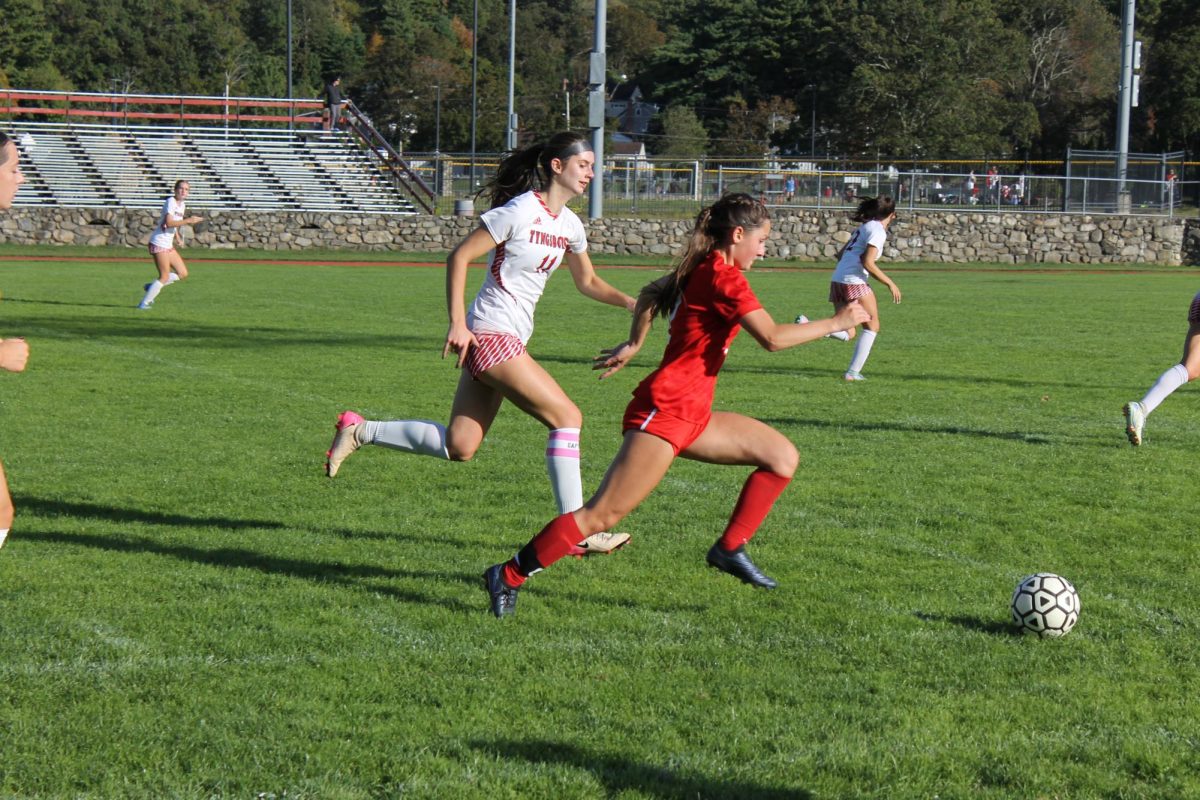 Senior Captain Makenna McGuire,2 stealing the ball and making her way towards Tyngsboro's goal  