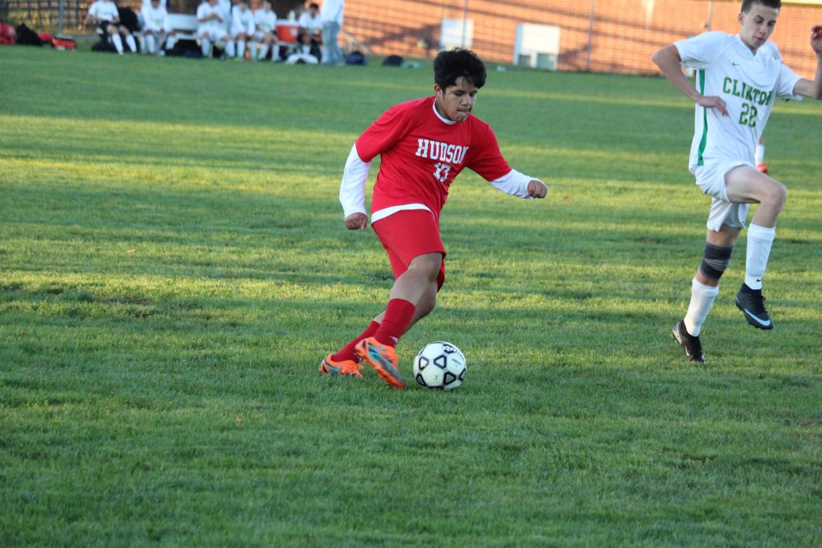 Freshmen Center Back Carlos Martinez Ramos dribbles the ball and fakes out Clinton player | by Henry Maver