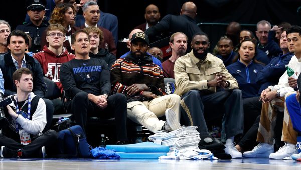 Mark Cuban, Kyrie Irving and Tim Hardaway Jr. sit courtside during the game against the Chicago Bulls at American Airlines Center on April 07, 2023. |Photo by Tim Heitman/Getty Images|